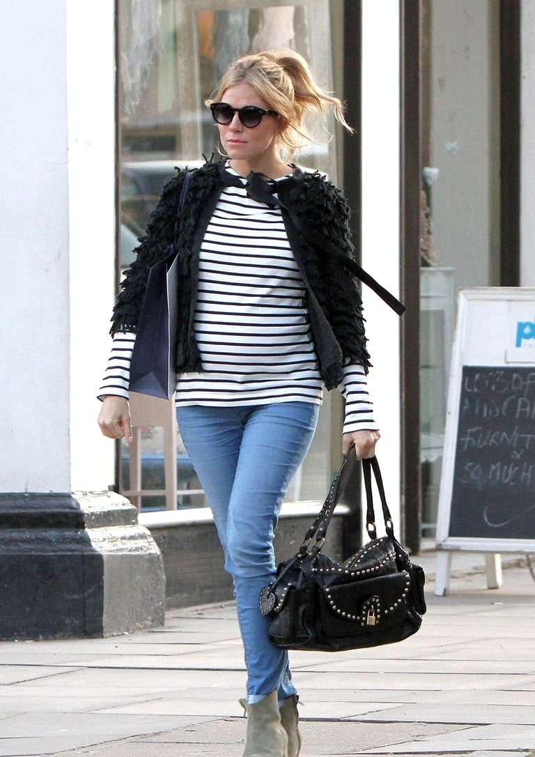 A heavily pregnant Sienna Miller shows off her growing baby bump while filming a commerical advert in Primrose Hill, London