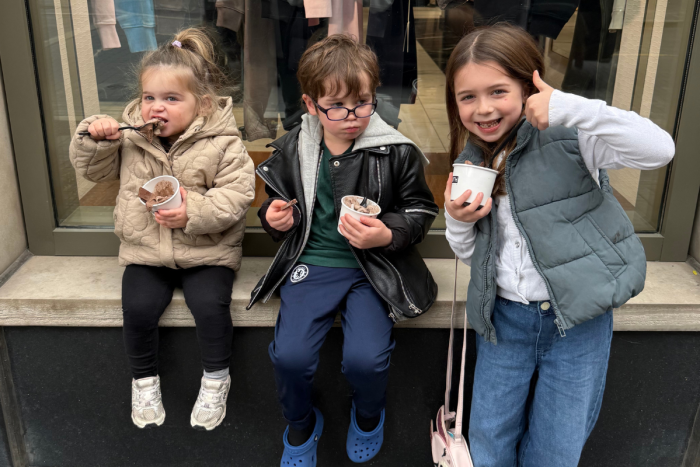 Three children enjoying ice cream outside Kith in Toronto