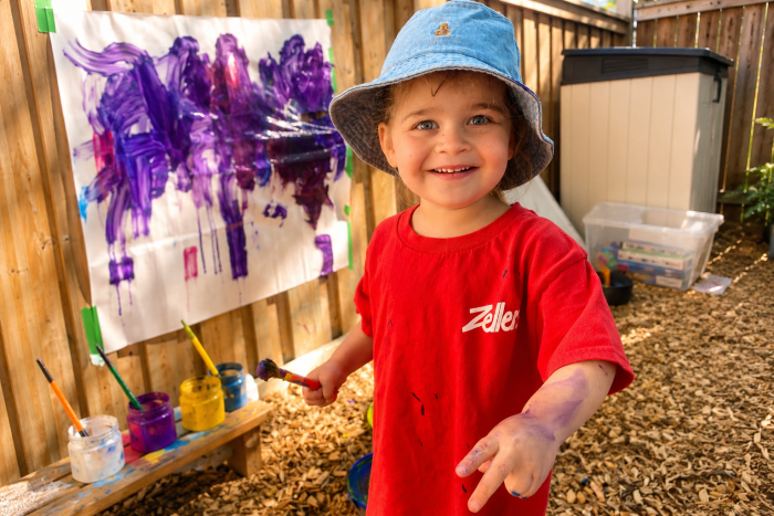 Child wearing a red Zellers T-shirt
