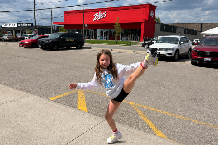 Child posing outside a Zellers store during a back-to-school shopping trip